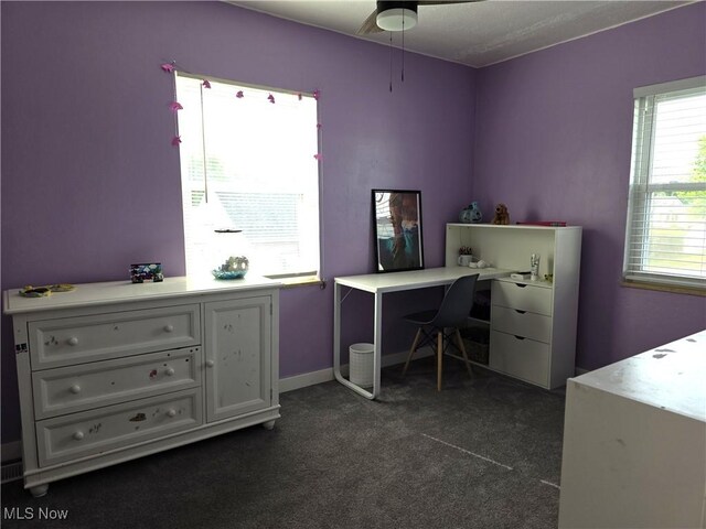 home office with dark colored carpet and ceiling fan