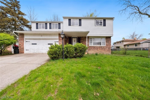 view of front of property with brick siding, fence, a front lawn, concrete driveway, and an attached garage