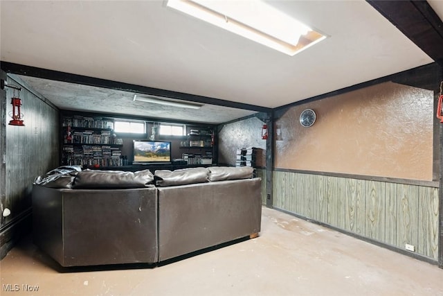 living area with wood walls and concrete floors