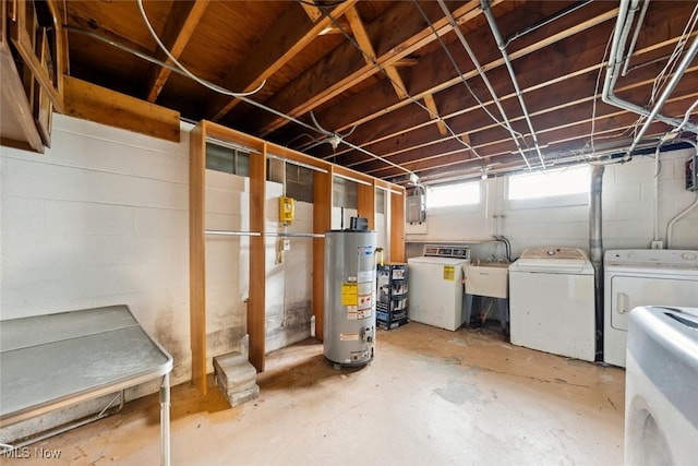 basement featuring a sink, gas water heater, and washing machine and clothes dryer