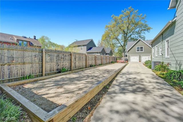 exterior space featuring driveway, a residential view, fence, cooling unit, and an attached garage