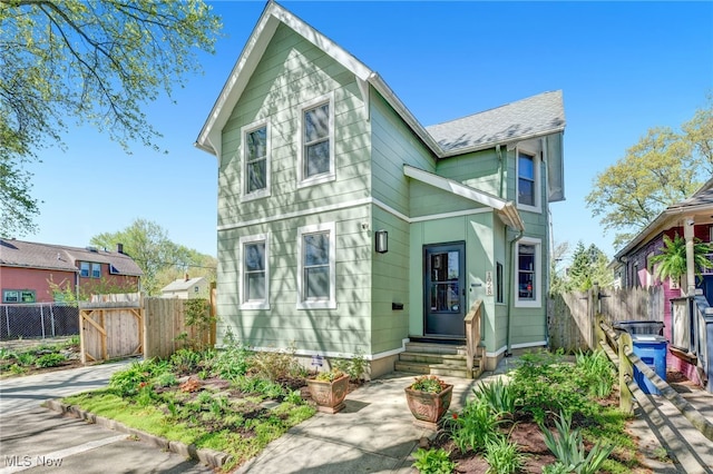 victorian home featuring fence and entry steps