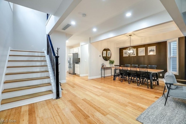 interior space featuring visible vents, recessed lighting, light wood-style flooring, and stairway