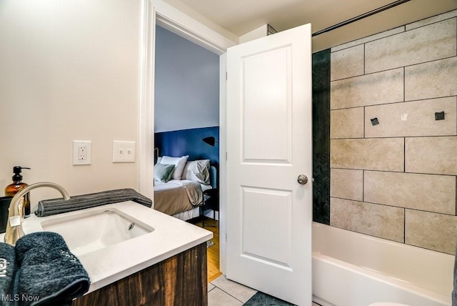 ensuite bathroom featuring tub / shower combination, ensuite bathroom, tile patterned flooring, and vanity