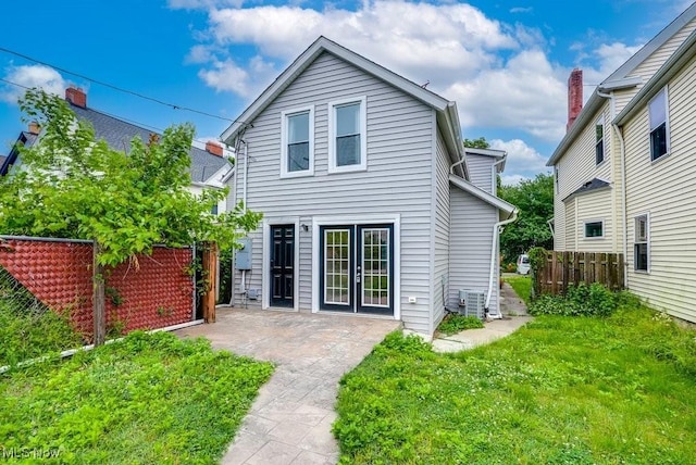 back of house with a yard, a patio, fence, and french doors