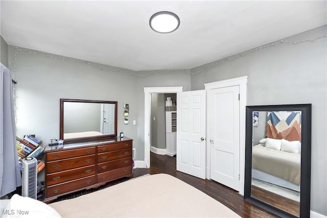 bedroom featuring baseboards and wood finished floors