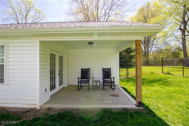 view of patio with french doors and fence
