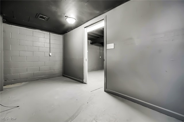 interior space featuring concrete block wall and visible vents