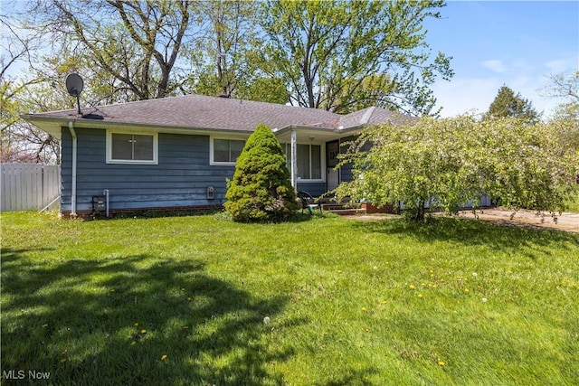 exterior space featuring fence and a yard