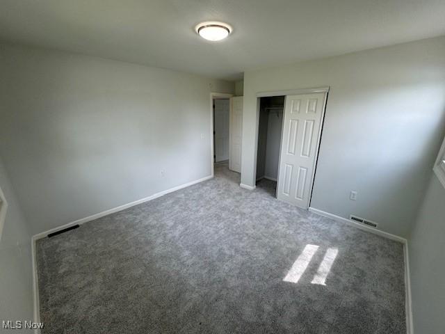6720 Prior Rd, Nashport, OH 43830 - unfurnished bedroom featuring a closet, baseboards, carpet flooring, and visible vents