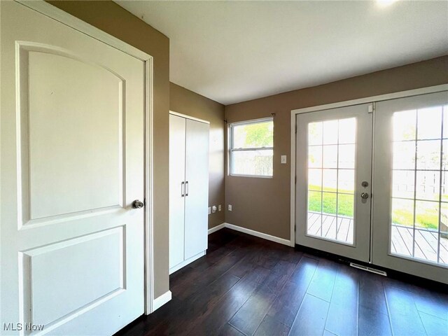 entryway featuring baseboards, dark wood-style floors, and french doors