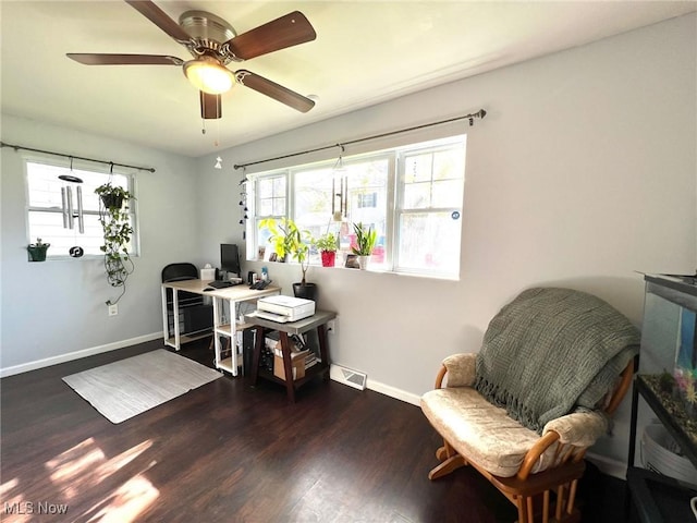 office featuring baseboards, ceiling fan, wood finished floors, and visible vents