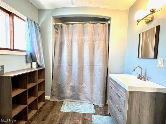 bathroom featuring vanity, curtained shower, wood finished floors, and visible vents