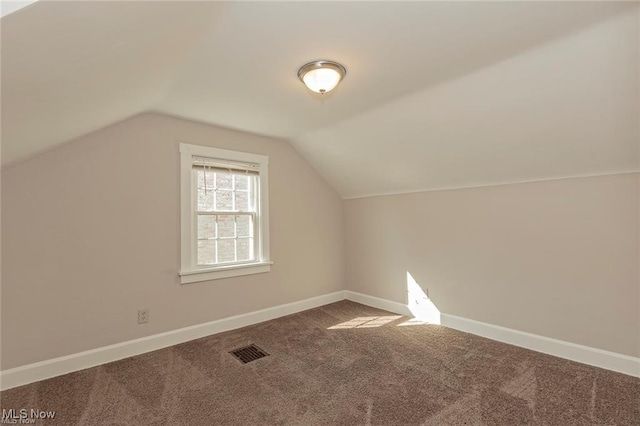 bonus room with carpet flooring, baseboards, visible vents, and vaulted ceiling