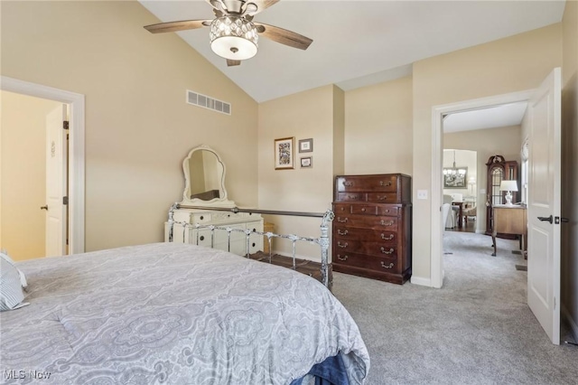 carpeted bedroom with baseboards, visible vents, ceiling fan with notable chandelier, and high vaulted ceiling
