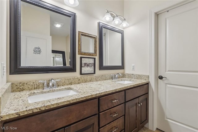 full bath featuring double vanity and a sink