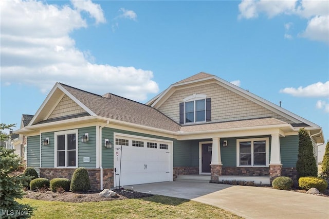 craftsman house featuring covered porch, a garage, concrete driveway, a shingled roof, and stone siding