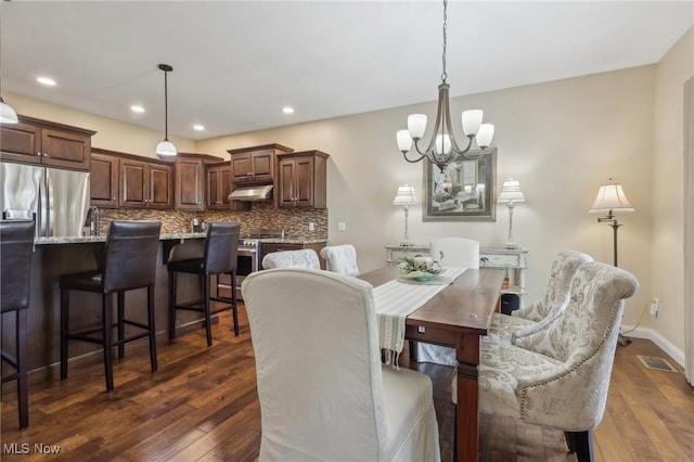 dining area with dark wood-type flooring, recessed lighting, a notable chandelier, and visible vents