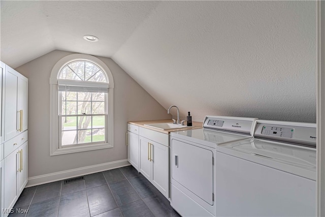 3340 Woodling Way, Medina, OH 44256 - laundry room with washing machine and clothes dryer, visible vents, cabinet space, a sink, and baseboards