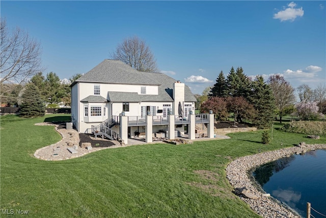 3340 Woodling Way, Medina, OH 44256 - back of property featuring a deck with water view, stairway, a chimney, a lawn, and a patio