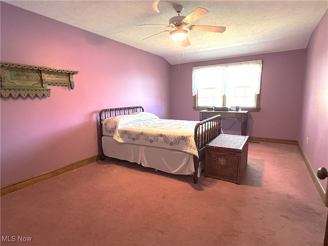 carpeted bedroom with baseboards, a ceiling fan, and a textured ceiling