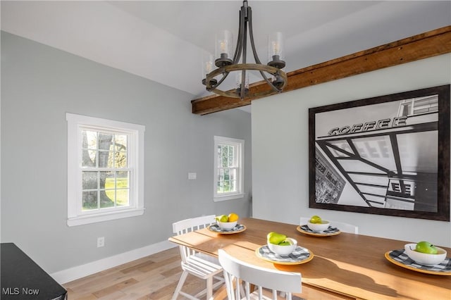 dining room with baseboards, a chandelier, vaulted ceiling with beams, and light wood-type flooring