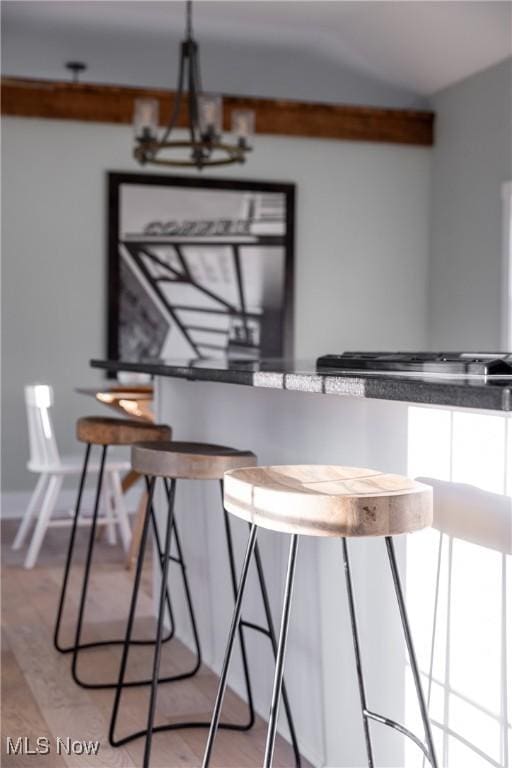 unfurnished dining area with a notable chandelier and light wood-style floors