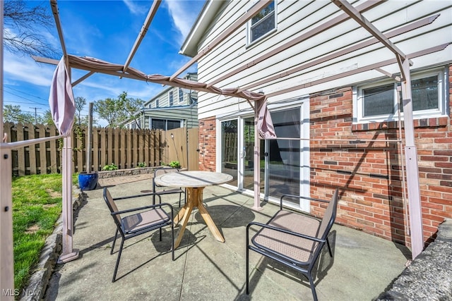 view of patio with fence and outdoor dining space