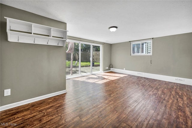 unfurnished room featuring baseboards and wood finished floors