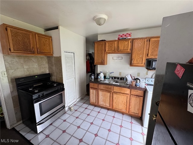 kitchen with a sink, light floors, brown cabinets, and stainless steel appliances