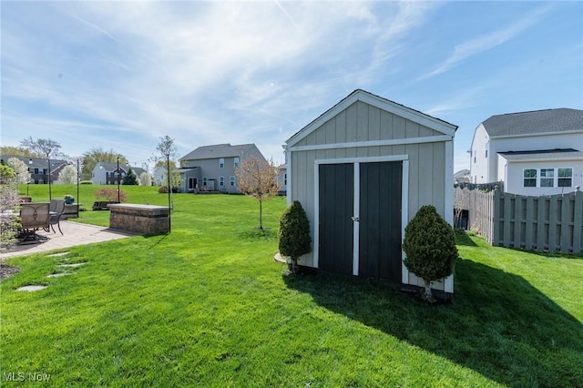 view of shed with fence and a residential view