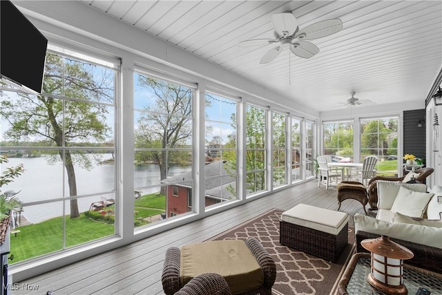 sunroom featuring a water view, a wealth of natural light, and ceiling fan