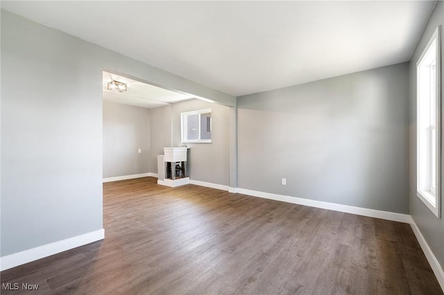 interior space featuring baseboards and wood finished floors