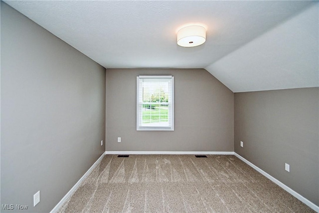 bonus room featuring visible vents, baseboards, carpet, and lofted ceiling