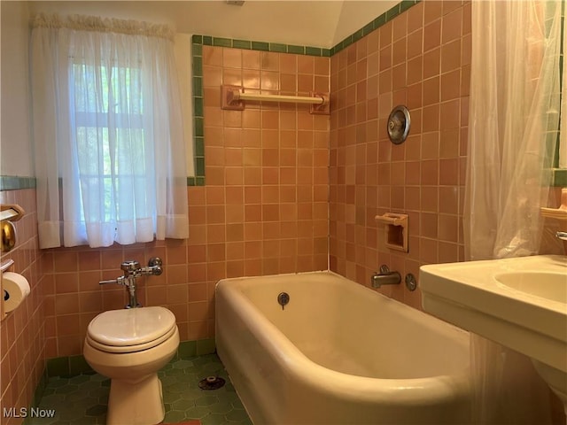 full bathroom featuring tile patterned floors, shower / bath combo, toilet, and tile walls