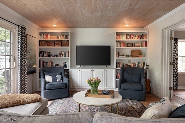 living area with built in features, crown molding, wooden ceiling, and a healthy amount of sunlight