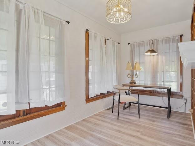 office area featuring an inviting chandelier and light wood finished floors