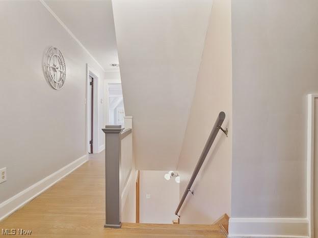 stairs featuring baseboards and wood finished floors