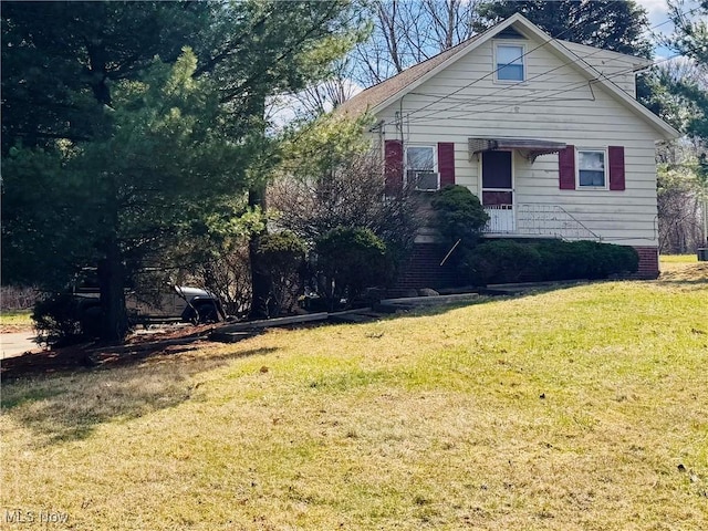 bungalow-style home with a front lawn
