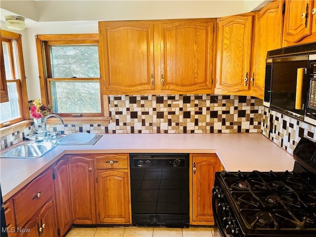 25911 Tryon Rd, Oakwood Village, OH 44146 - kitchen with black appliances, light countertops, a sink, and tasteful backsplash