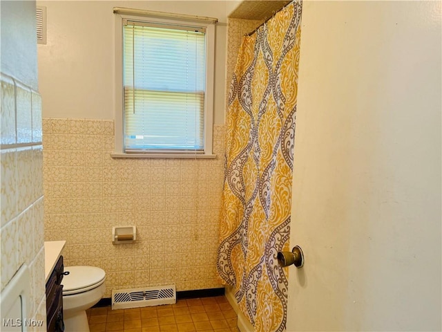 full bathroom with visible vents, tile patterned flooring, wainscoting, vanity, and toilet