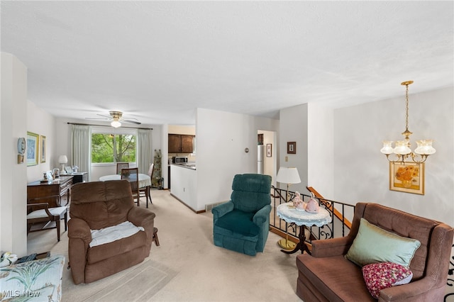living area featuring light colored carpet and ceiling fan with notable chandelier