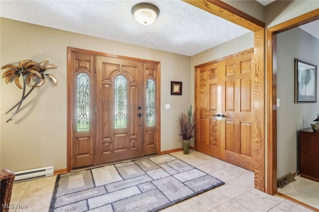 entryway featuring light tile patterned flooring, baseboards, a textured ceiling, and a baseboard radiator