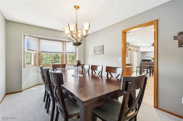 dining space featuring baseboards, a wealth of natural light, and light colored carpet