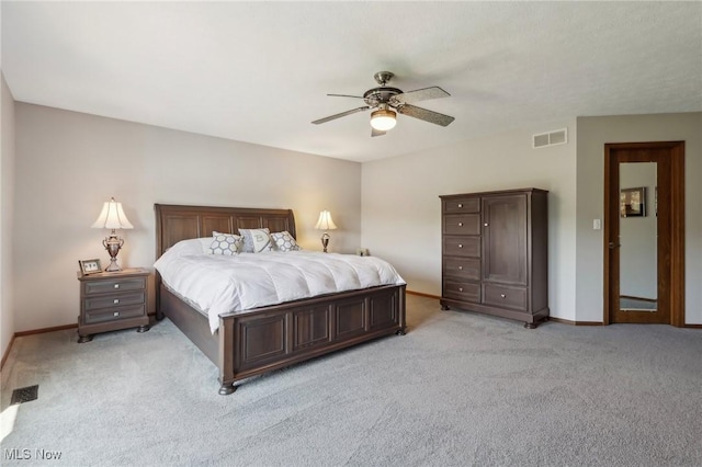 bedroom featuring baseboards, visible vents, and light carpet