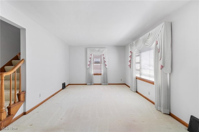 unfurnished room with baseboards, carpet flooring, and stairway