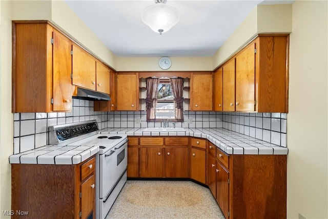 kitchen with a sink, electric range, under cabinet range hood, and brown cabinets