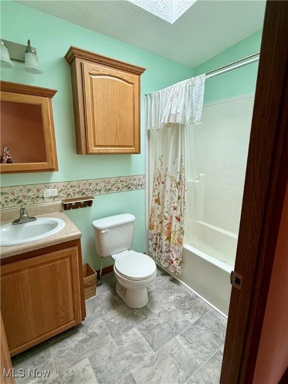 full bath featuring vanity, toilet, shower / bathtub combination with curtain, a textured ceiling, and a skylight