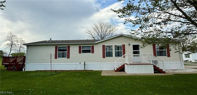 rear view of property featuring a yard