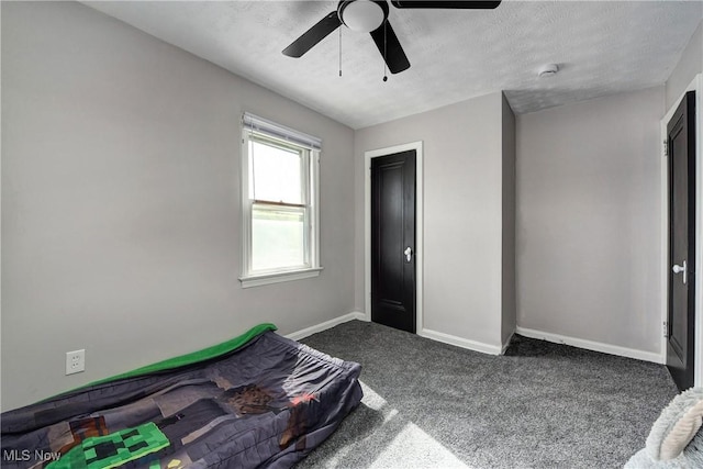 bedroom featuring baseboards, a ceiling fan, and carpet